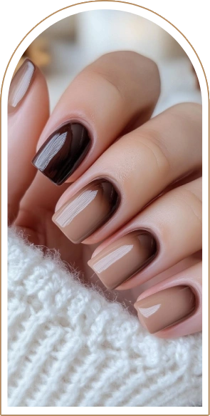 hand with brown manicure is holding white sweater